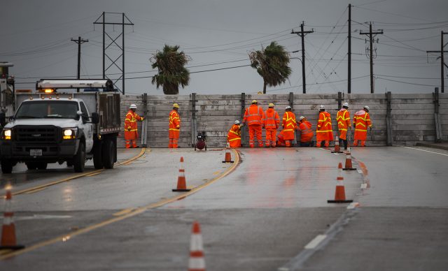 Crews install the final portion of a surge wall in Aransas Pass, Texas