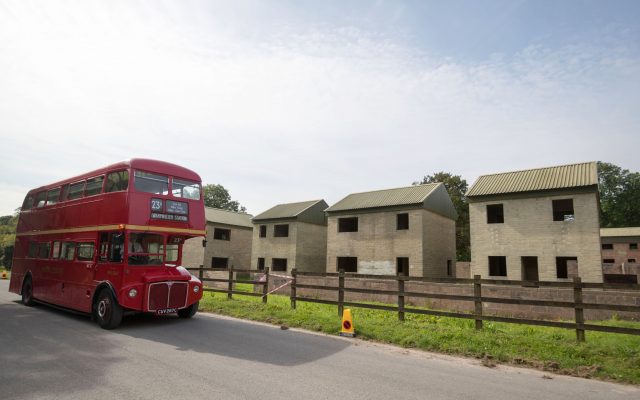 A bus drives through the abandoned village of Imber