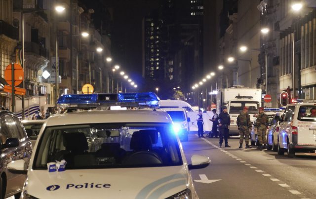 Police and Belgian Army soldiers secure the scene in downtown Brussels