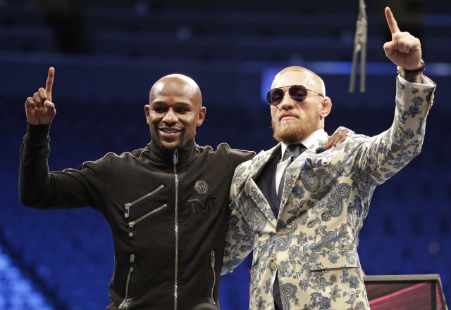 Conor McGregor and Floyd Mayweather pose together at a press conference