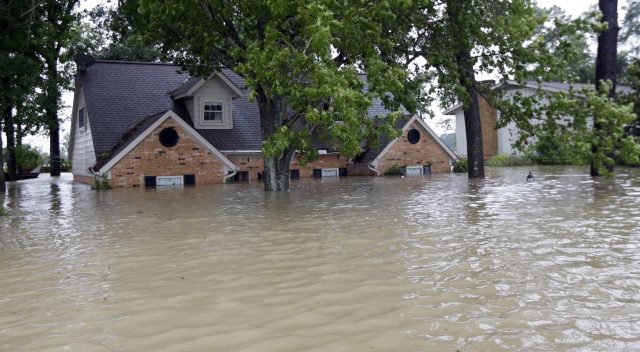 A home is surrounded by floodwaters (David J Phillip/AP)