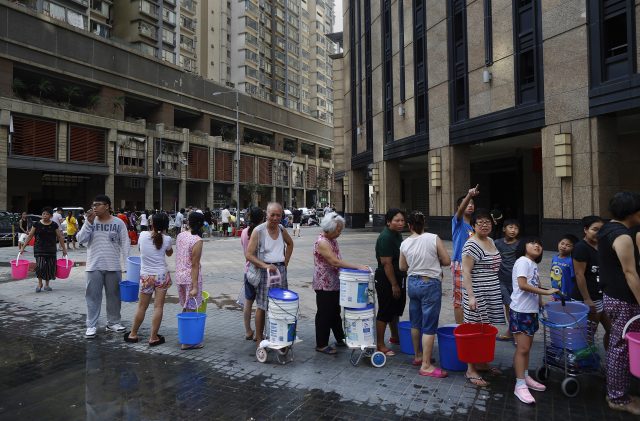 Residents queue up for water due to cuts of water and power caused by Typhoon Hato in Macau, China