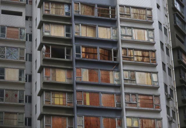 Windows are covered by wood boards which were damaged by Typhoon Hato in Macau, China