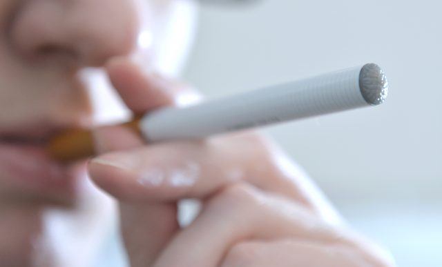 A person smoking an e-cigarette