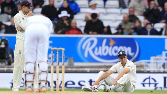 England's Alistair Cook (right) appears dejected after dropping a catch off West Indies Jermaine Blackwood