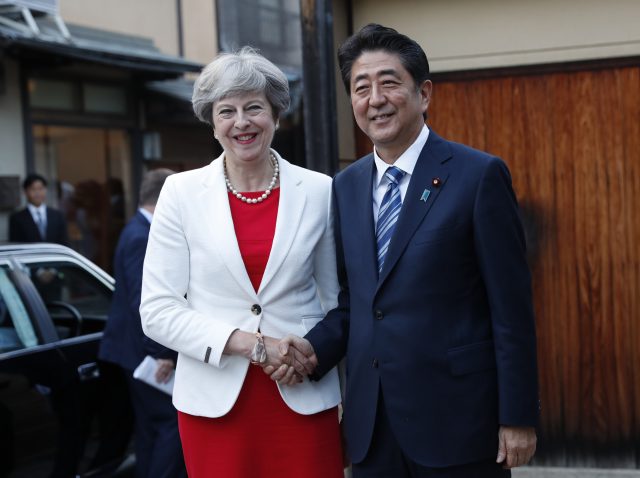 Theresa May is welcomed by Japan's Prime Minister Shinzo Abe