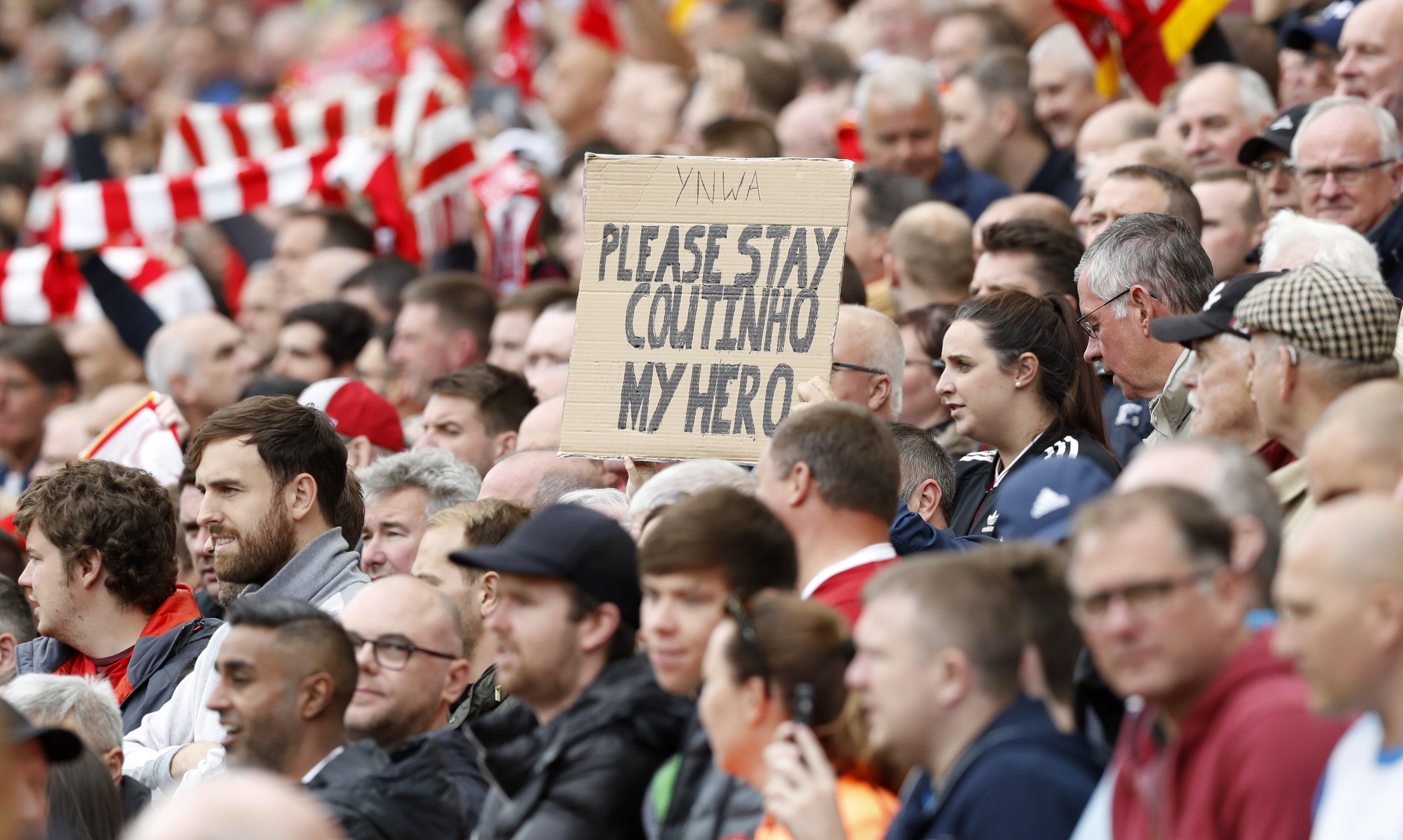 A Liverpool fan holds a sign up during the game