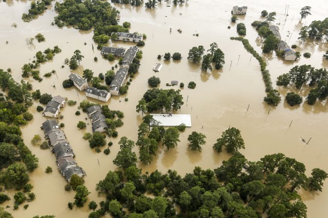 Floodwaters from the San Jacinto River surround houses in Kingwood (Brett Coomer/Houston Chronicle via AP)