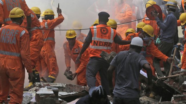 Rescuers work at the site of a building collapse in Mumbai