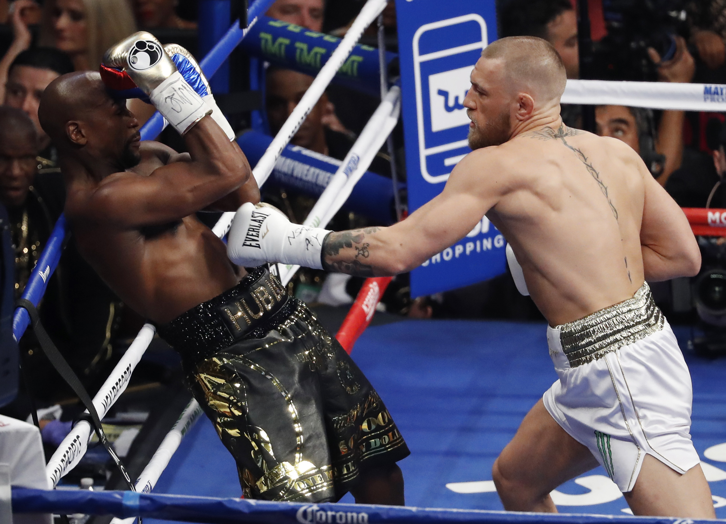 Conor McGregor hits Floyd Mayweather Jr. in a super welterweight boxing match