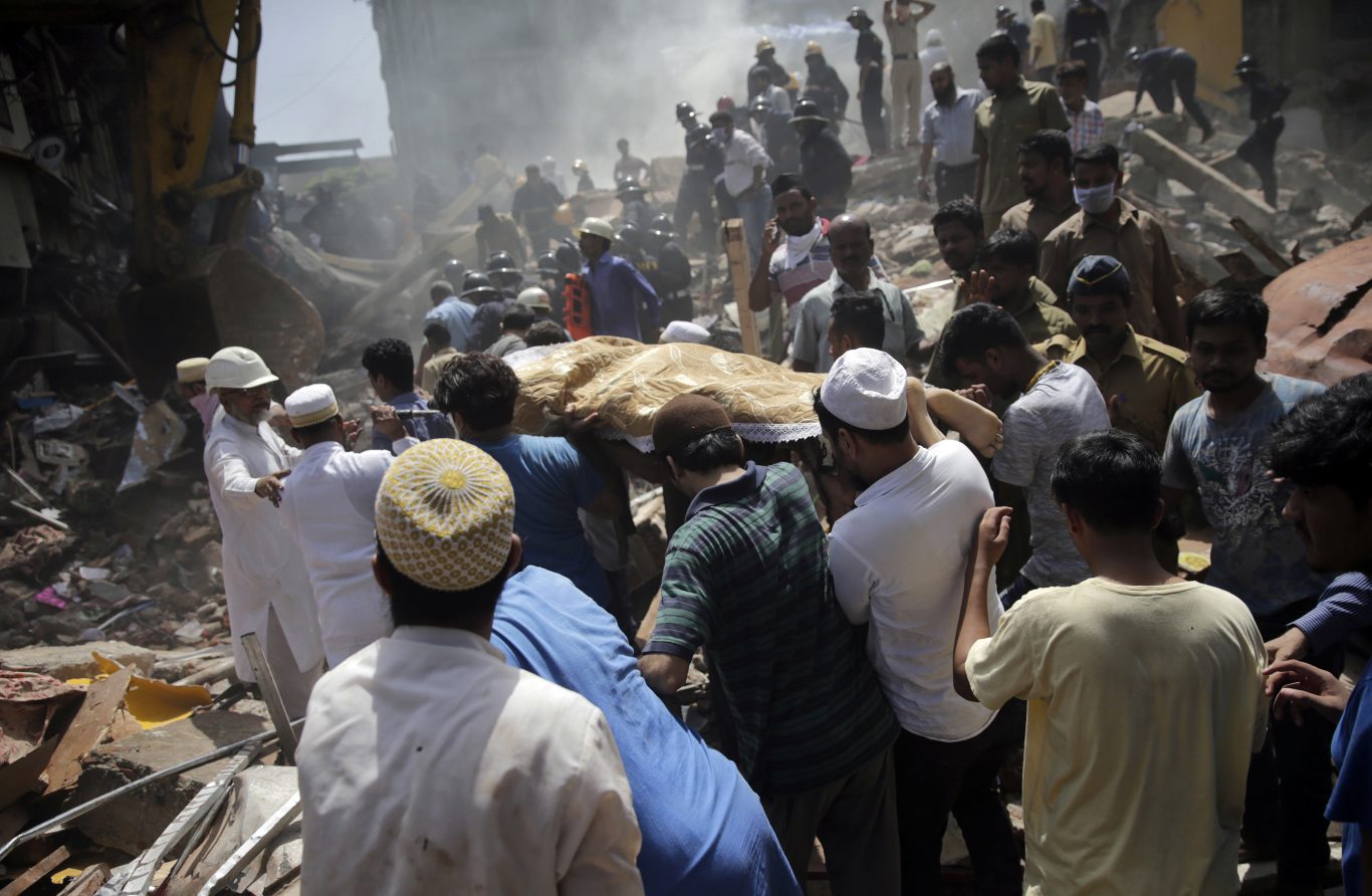 The body of a victim is carried out from the site of a building collapse in Mumbai, India (Rafiq Maqbool/AP)