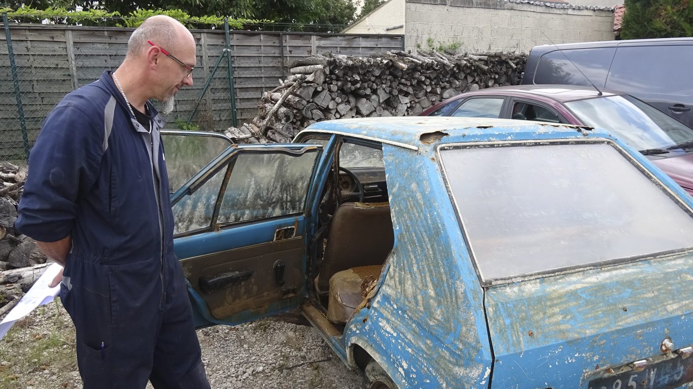 French mechanic Franck Menard stands next to the Peugeot 104 which was recovered this week 38 years after it was stolen (Chris den Hond/AP)