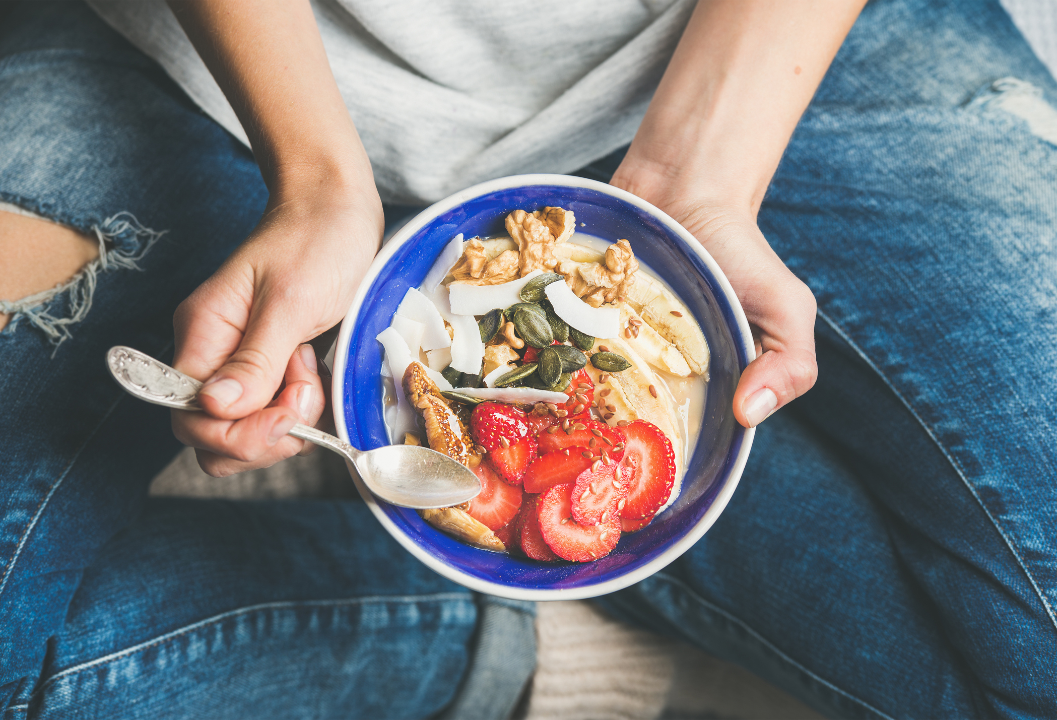 Generic photo of woman sat on the floor eating bowl of healthy food (Thinkstock/PA)