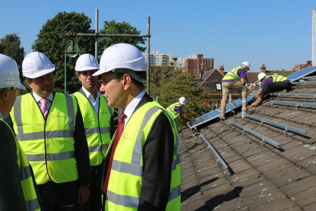 International Trade Minister Greg Hands visiting a social housing development in Ealing. (PA)