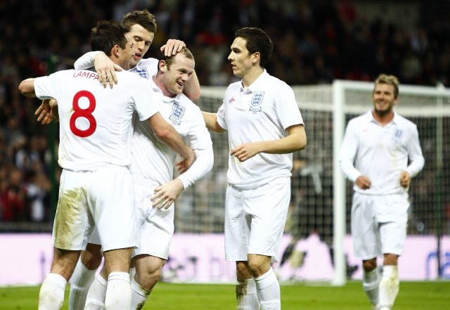 Wayne Rooney celebrates with his England team-mates after scoring against Slovakia in 2009