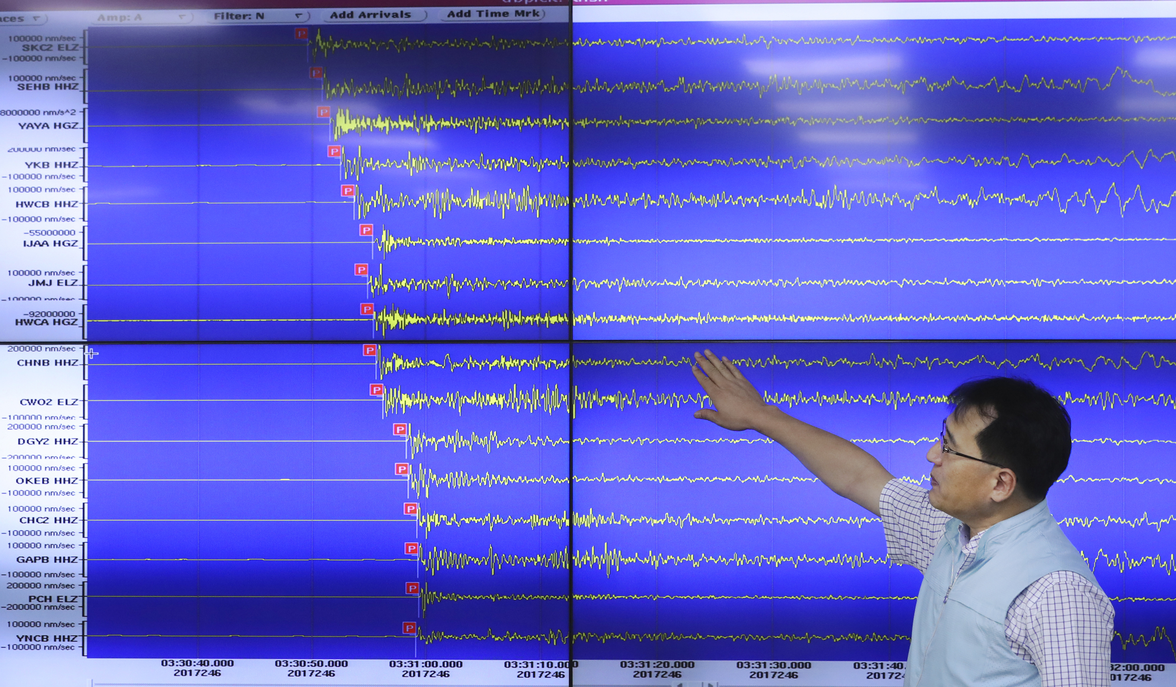 A South Korean man looks at the Earthquake readings