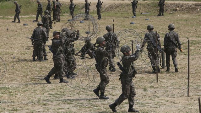 South Korean army soldiers prepare barbed wires during a military exercise in Paju