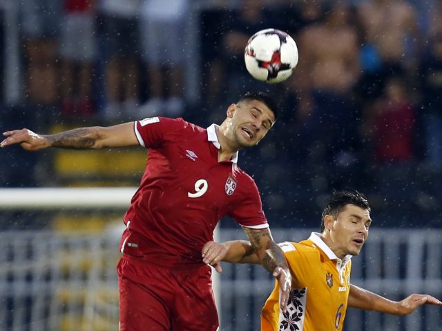 Serbia's Aleksandar Mitrovic, left, challenges Moldova's Alexandru Epureanu, during the World Cup Group D  match against Moldova