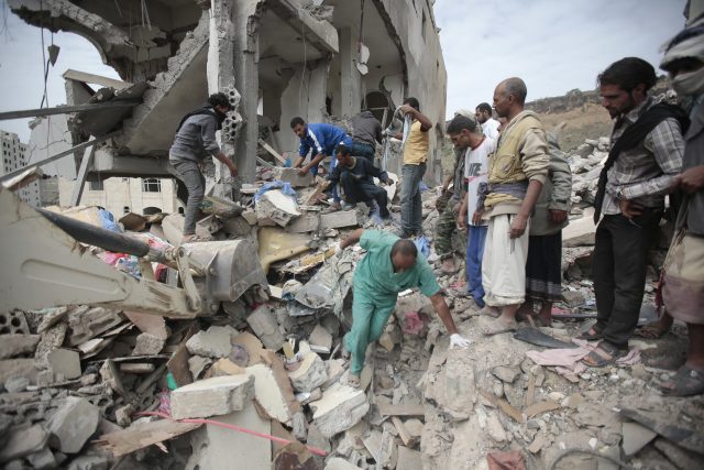 People inspect the rubble of houses destroyed by Saudi-led air strikes in Sanaa, Yemen