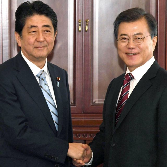 Japanese prime minister Shinzo Abe greets South Korean president Moon Jae-in