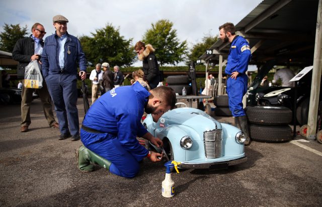 A mechanic works on a pedal car used in the The Settrington Cup (Andrew Matthews/PA)
