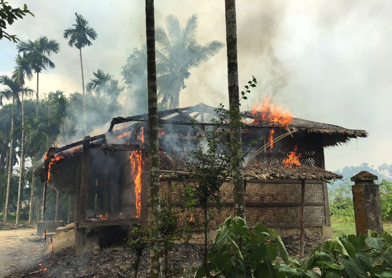 Journalists saw new fires burning Thursday in the village that had been abandoned by Rohingya Muslims, and where pages from Islamic texts were seen ripped and left on the ground (AP)