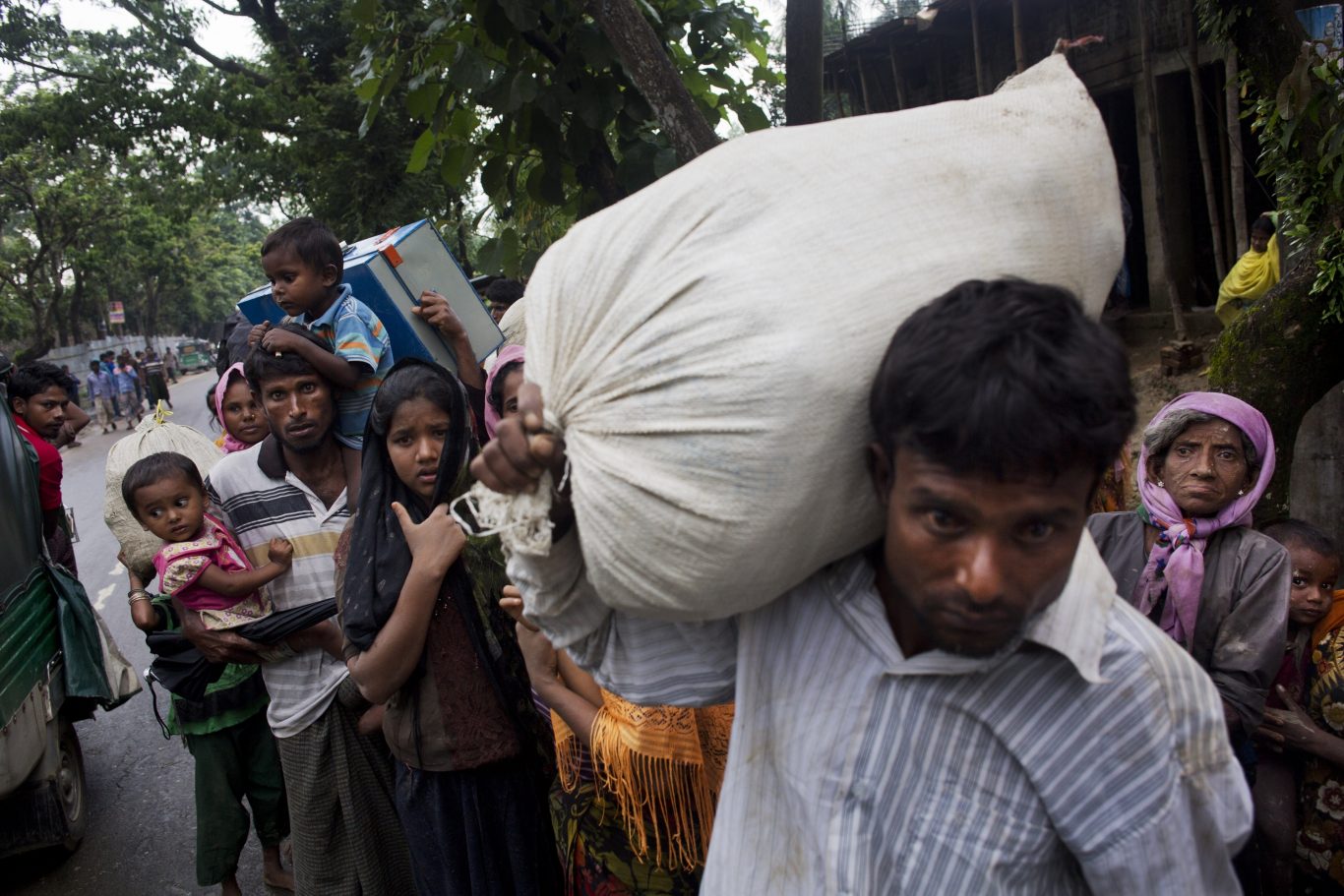 Burma's Rohingya ethnic minority refugees walk after crossing the Bangladeshi border near Cox Bazar's in the Kanjopara area Bangladesh (Bernat Armangue/AP) 