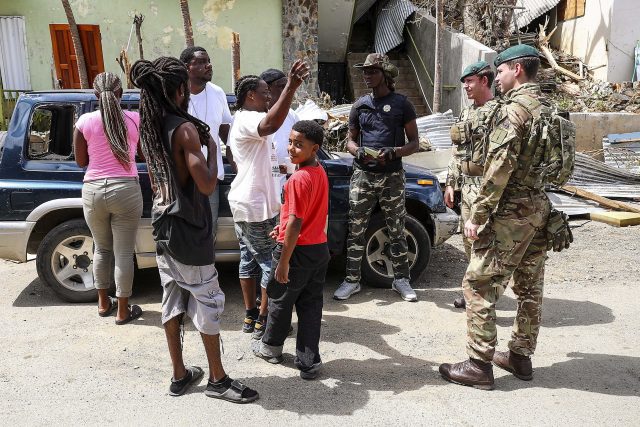 Royal Marines of 40 Commando speaking to the locals in Tortola in the British Virgin Isles who have had their homes devastated by Hurricane Irma