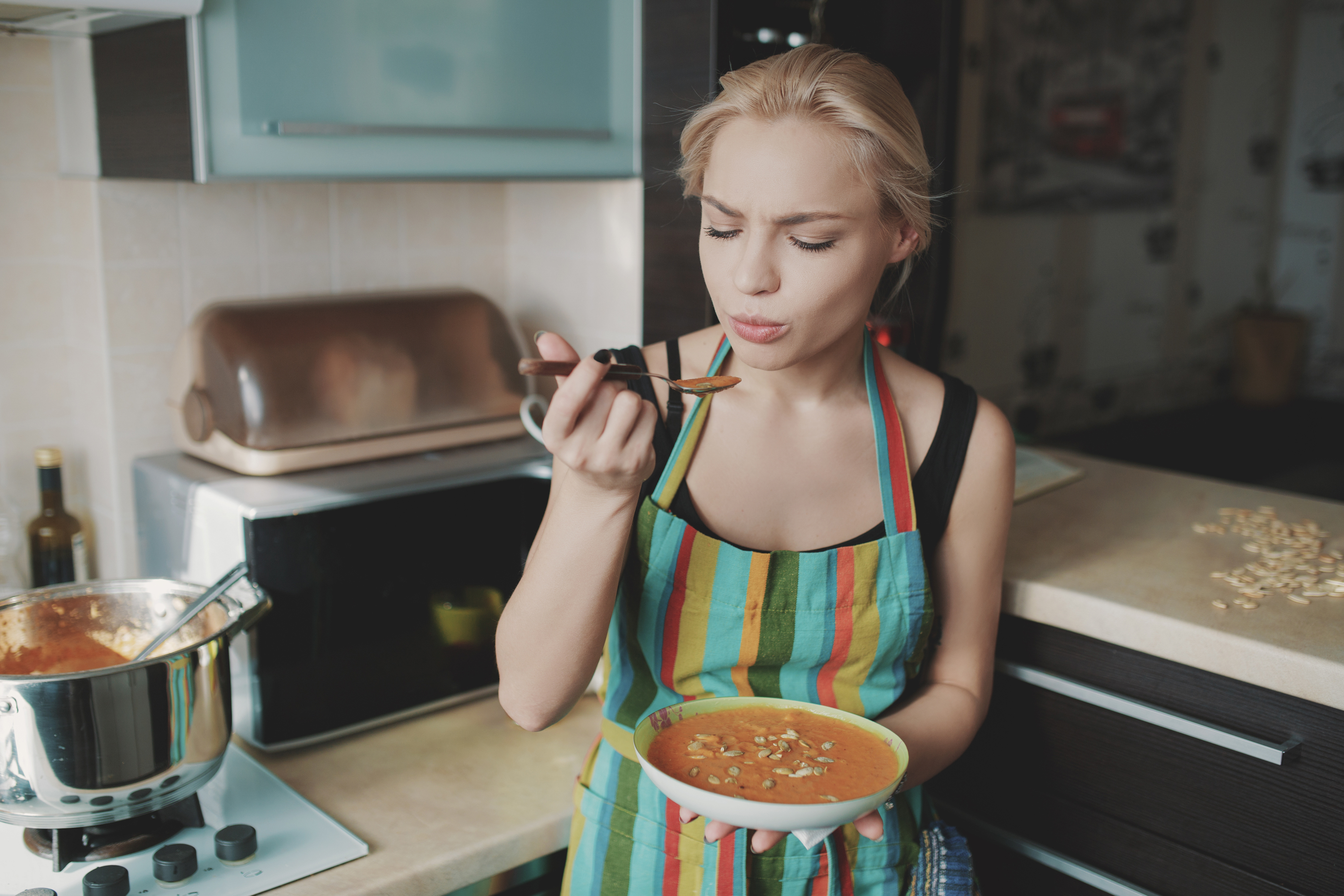 Young woman enjoying pumpkin soup in kitchen (thinkstock/pa)