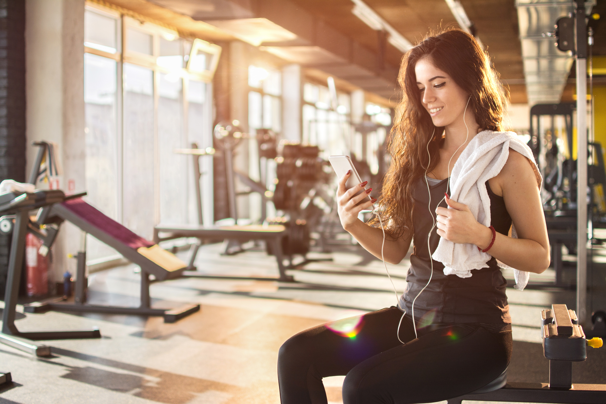 Generic photo of young woman in gym looking at her phone (thinkstock/pa)