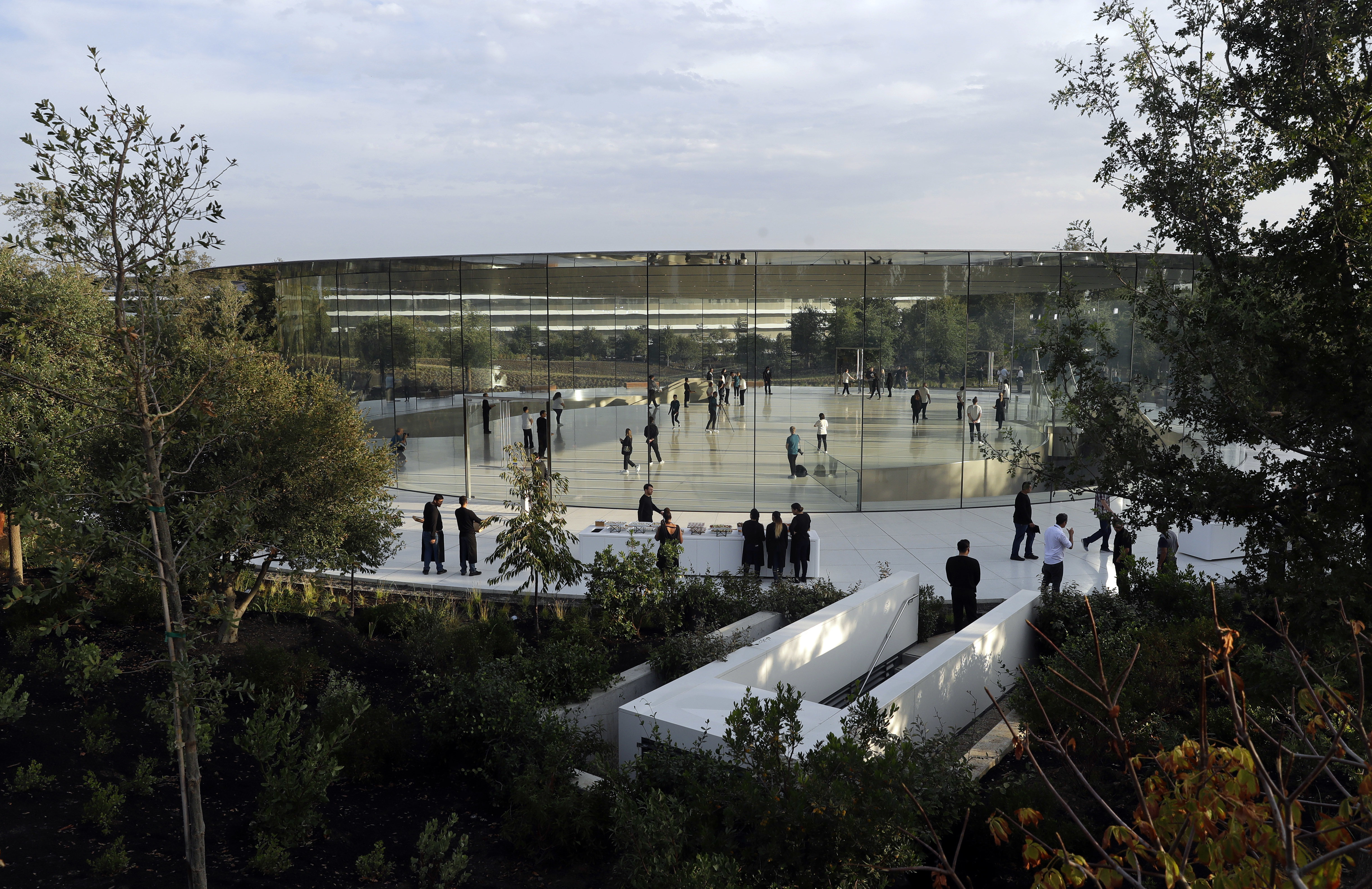 People arrive for a new Apple announcement at the Apple Park