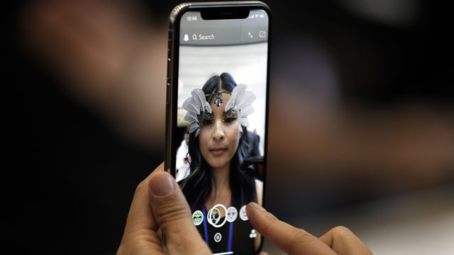 The new iPhone X is displayed in the showroom after the new product announcement at the Steve Jobs Theater on the new Apple campus on Tuesday, Sept. 12, 2017, in Cupertino, Calif. 