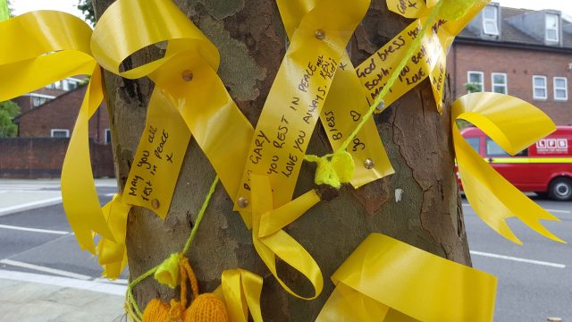 Memorial ribbons tied around a tree close to where the Grenfell Tower fire inquiry is taking place 
