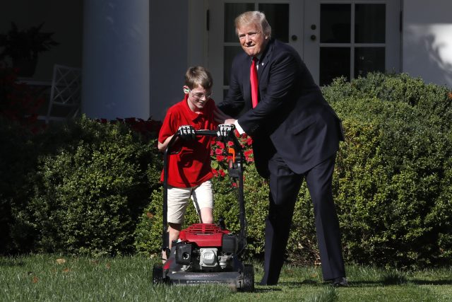 Frank Giaccio, 11,  is encouraged by President Donald Trump while he mowed the lawn in the Rose Garden at the White House (Jacquelyn Martin/AP)