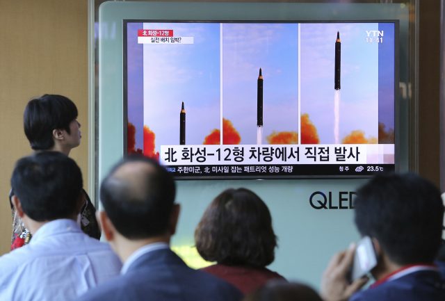 People in South Korea watch a TV showing news about North Korea's missile launch. (Ahn Young-joon/AP/PA)
