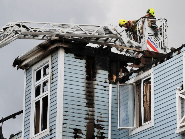 Firefighters examine the building