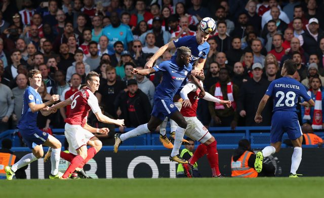 Chelsea defender Gary Cahill heads away from danger