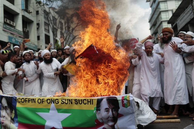 Activists burn a Burmese flag