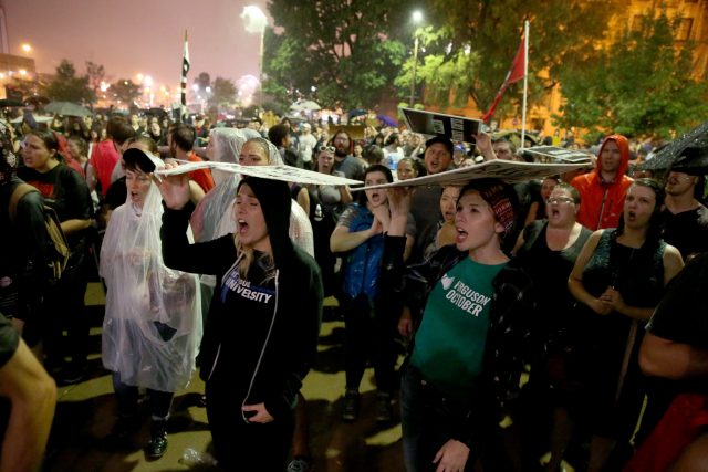 Hundreds of protesters gather in the rain outside the St Louis city jail (David Carson/St Louis Post-Dispatch via AP)