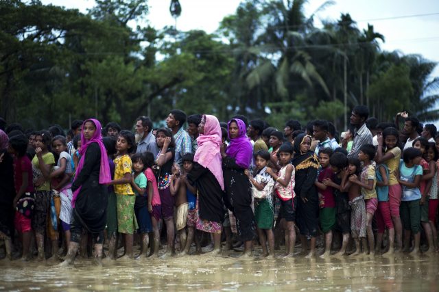 Rohingya Muslims who crossed over recently from Burma into Bangladesh, stand in a queue to receive food being distributed near Balukhali refugee camp in Cox's Bazar, Bangladesh (Bernat Armangue/AP)