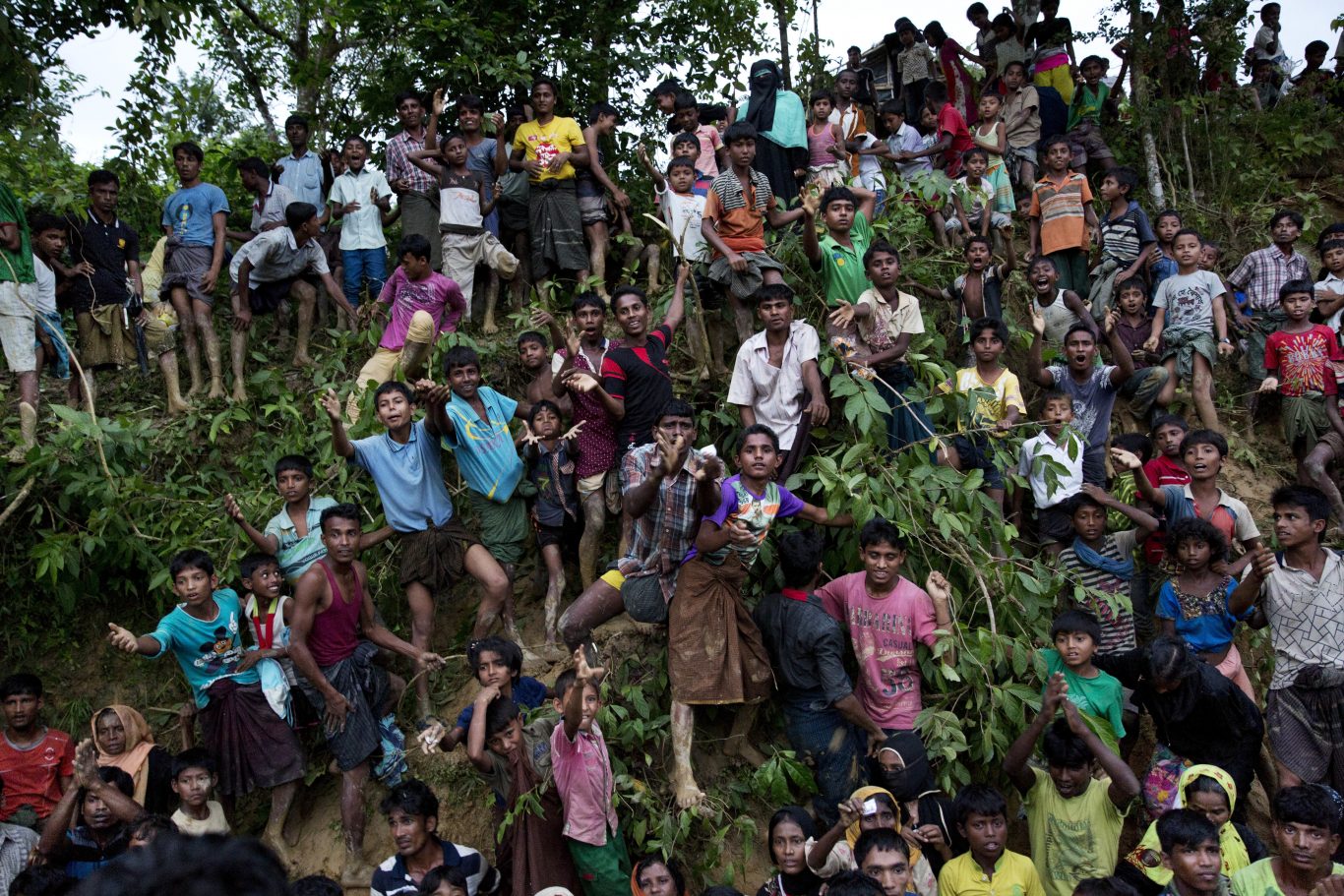 Young Rohingya Muslims stand on a slope before receiving food being distributed near Balukhali refugee camp in Cox's Bazar, Bangladesh (Bernat Armangue/AP)