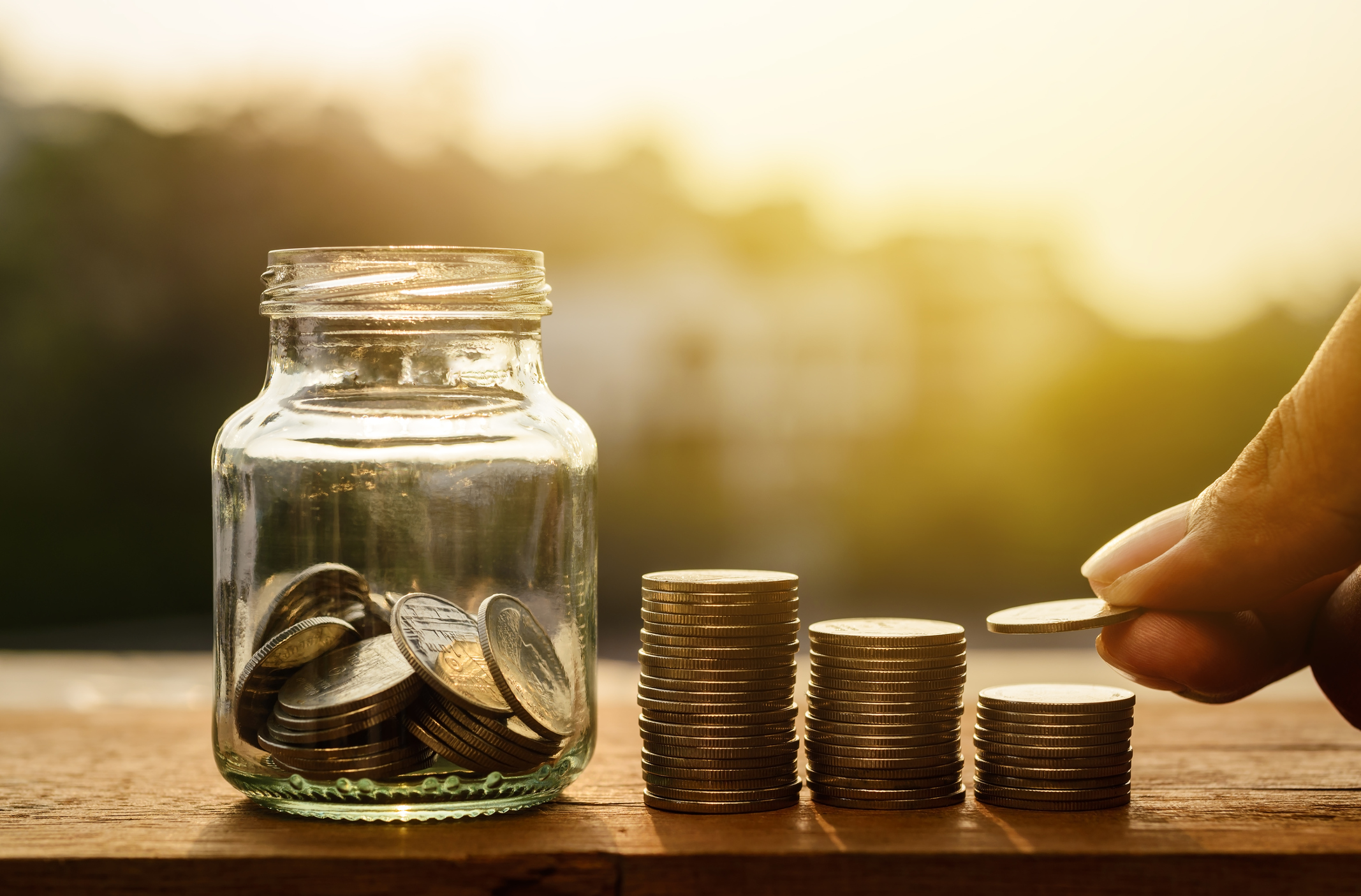 A savings jar with piles of coins (Thinkstock/PA)