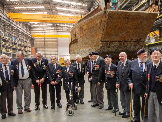 Veterans in front of the landing craft 