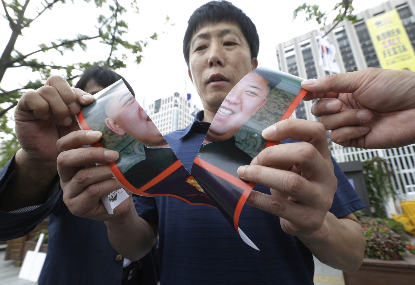 North Korean defector Park Sang Hak tears a portrait of North Korean leader Kim Jong Un during a rally against South Korean government's policy against the North in front of the Government Complex in Seoul, South Korea (Ahn Young-joon/AP)