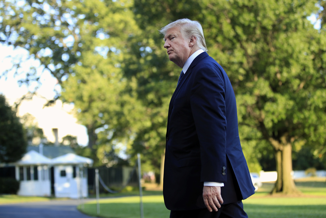 President Donald Trump walks towards the White House in Washington