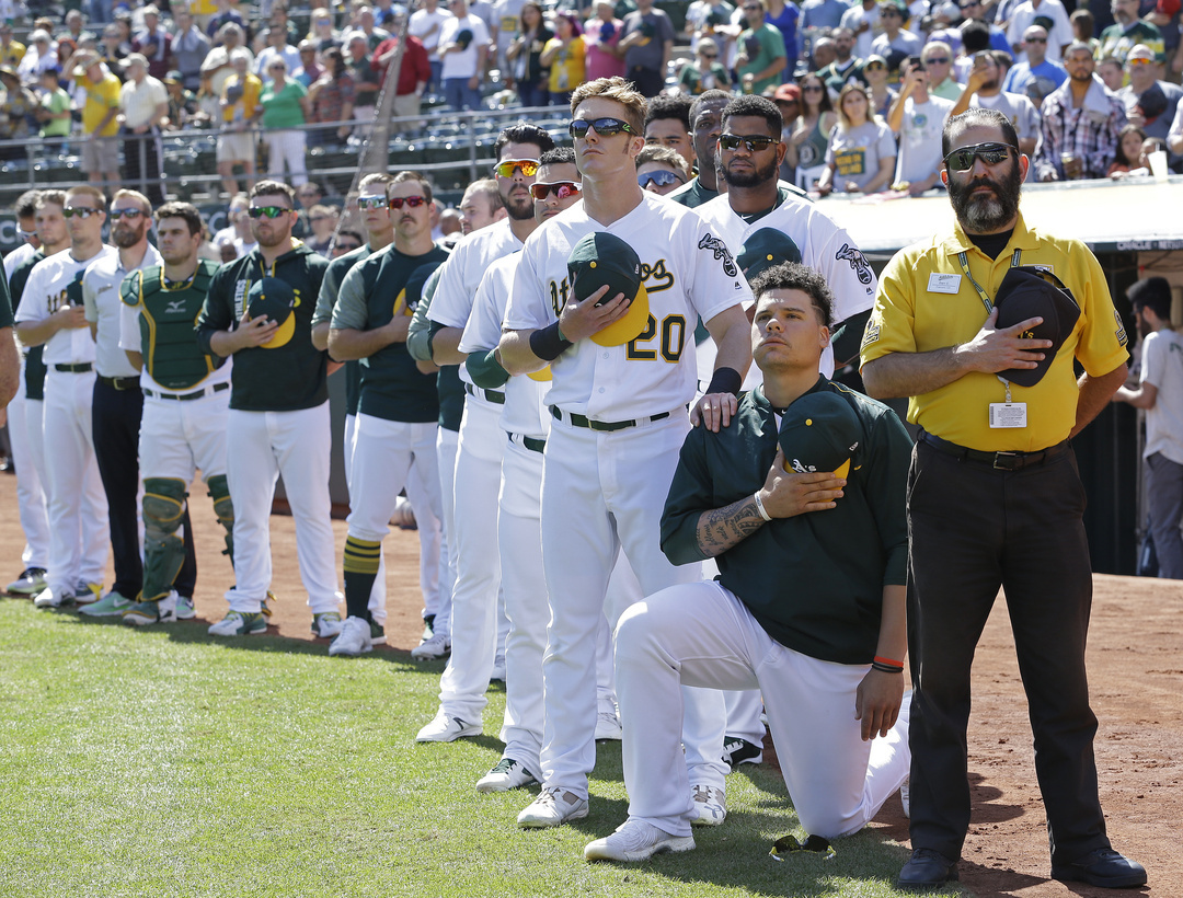 Oakland Athletics' Mark Canha (20) places his hand on the shoulder of Bruce Maxwell 