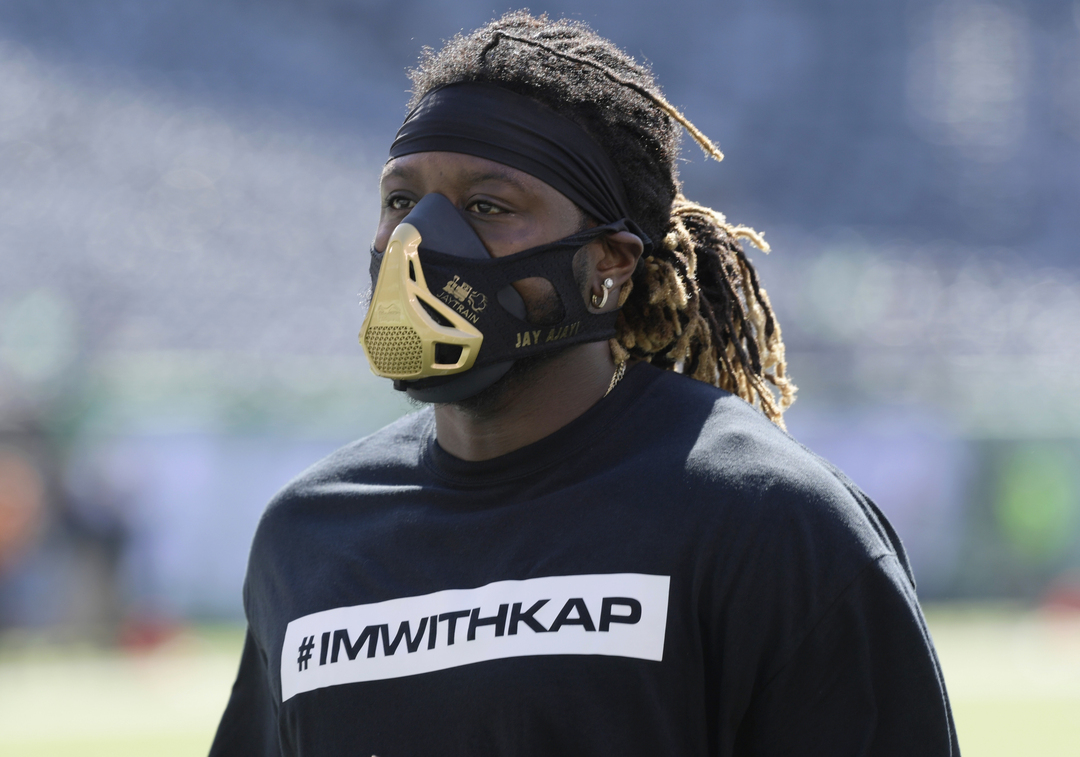 Miami Dolphins running back Jay Ajayi warms up in a #imwithkap shirt on Sunday (Bill Kostroun/AP)