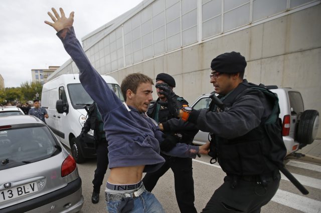 A man is grabbed by civil guards in Sant Julia de Ramis