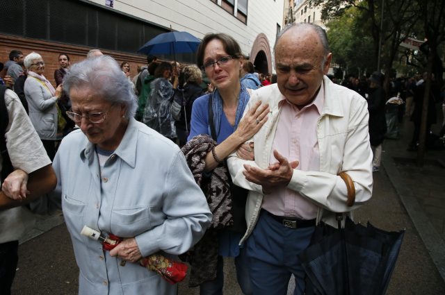 People cry after casting their ballots