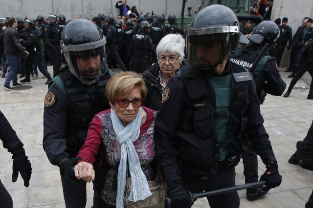 Civil guards escort a woman